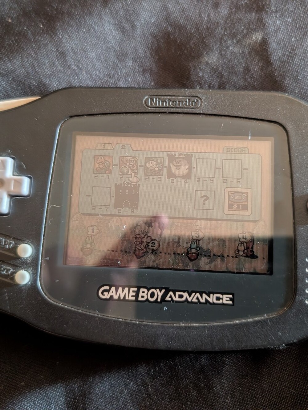 Game boy advance with Yoshi's island, super Mario advance 3